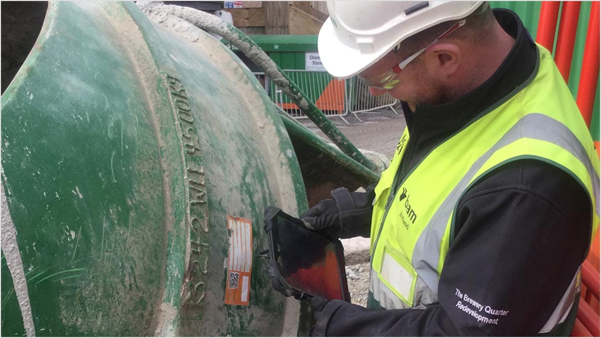 Person in construction hat viewing a tablet