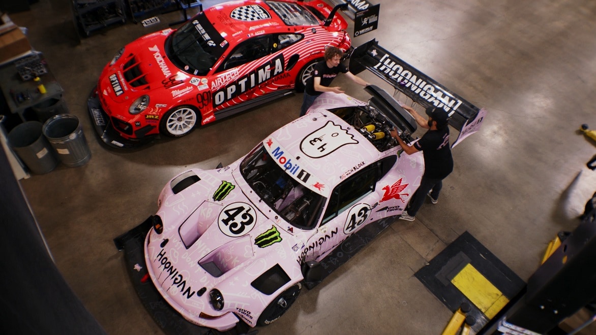 Members of the BBi Motorsports team work on a customized race car in their automotive shop.